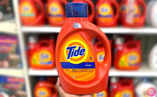 Hand Holding a Tide Liquid Laundry Detergent 64 Loads