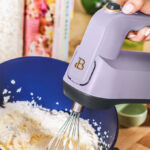 A Person Holding Beautiful by Drew Barrymore 6 Speed Electric Hand Mixer