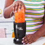 A Person Using Magic Bullet 4 Piece Personal Blender