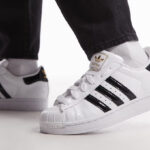A Person Wearing Adidas Originals Superstar II Casual Shoes