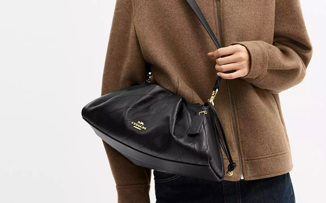 A Woman Wearing Coach Outlet Faye Large Shoulder Bag With Quilting A Woman Wearing Coach Outlet Faye Large Shoulder Bag With Quilting
