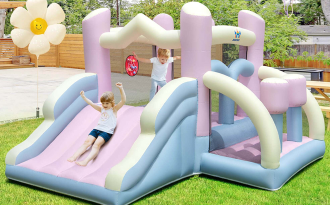 Kids Playing on the Costway Macron Pastel Bounce House with Slide