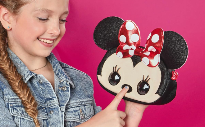 A Girl Pressing the Nose of Purse Pets Disney Minnie Mouse Interactive Pet Toy Kids Purse