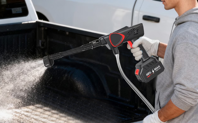 A Man Using the BAOKALER Cordless Pressure Washer