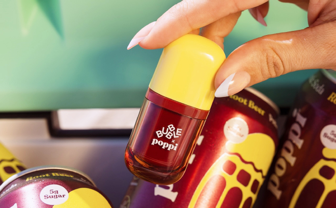 A Person Holding Bubble x Poppi Talk Back Root Beer Lip Serum