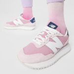 A Person Wearing New Balance 237 Sneakers in Pink Color