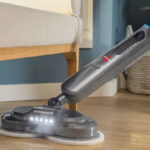 A Woman Cleaning with the Bissell SpinWave SmartSteam Spin Mop