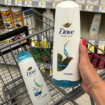 A person holding a Dove Conditioner at Walgreens