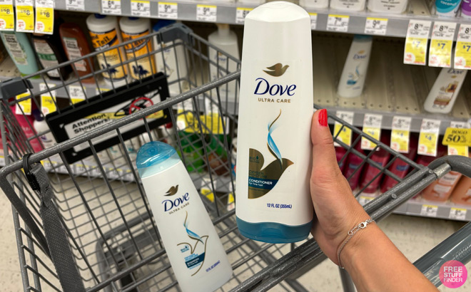 A person holding a Dove Conditioner at Walgreens