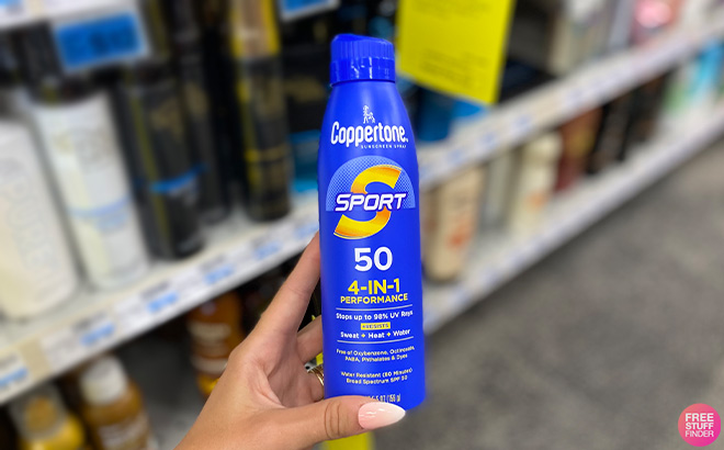 A Person Holding Coppertone SPORT Continuous Sunscreen Spray Broad Spectrum