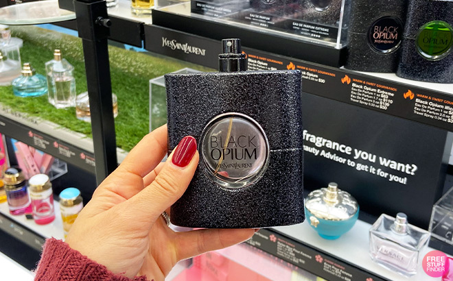 A Person Holding a Perfume inside a Store