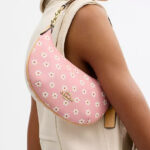 A Person Wearing the Coach Mini Payton Bag With Floral Print