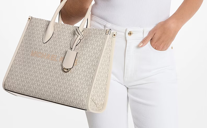 A Woman Holding Michael Kors Mirella Medium Signature Logo Tote Bag