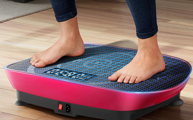 A Woman Using the Merach Vibration Plate Exercise Machine