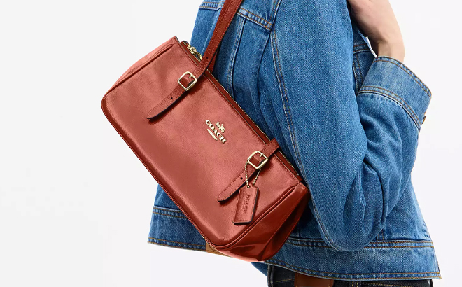 A Woman Wearing Coach Outlet Asher Shoulder Bag in Cinnamon A Woman Wearing Coach Outlet Asher Shoulder Bag in Cinnamon