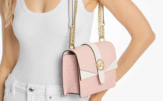 A Person Holding Michael Kors Greenwich Small Color Block Signature Logo Crossbody Bag