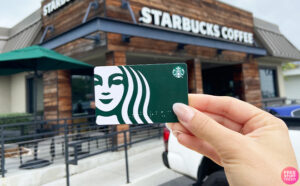 A Person Holding Starbucks Gift Card Storefront