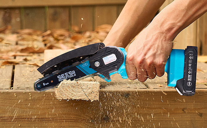 A Person Using Seesii Mini Chainsaw