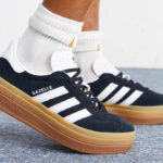 A Person Wearing Adidas Gazelle Womens Bold Athletic Shoes