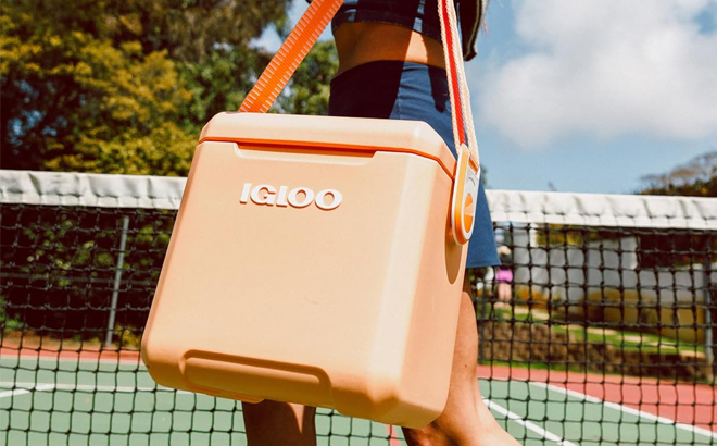 A Woman Holding Igloo 11 Quart Tag Along Too Cooler in Apricot