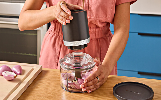 A Woman Using the KitchenAid Go Cordless Top Down Food Chopper
