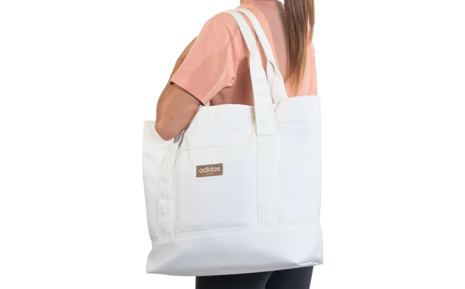 A Woman Wearing Adidas Canvas Court Tote Bag A Woman Wearing Adidas Canvas Court Tote Bag