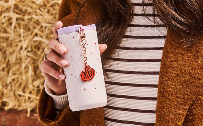 A Person Holding Starbucks Stainless Steel Tumbler with PSL Charm A Person Holding Starbucks Stainless Steel Tumbler with PSL Charm