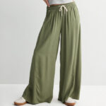 A Person Wearing Juniors SO High Rise Baggy Wide Leg Pants in Drew Green