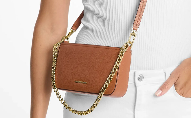 A Person Wearing Michael Kors Bryant Small Leather Convertible Crossbody