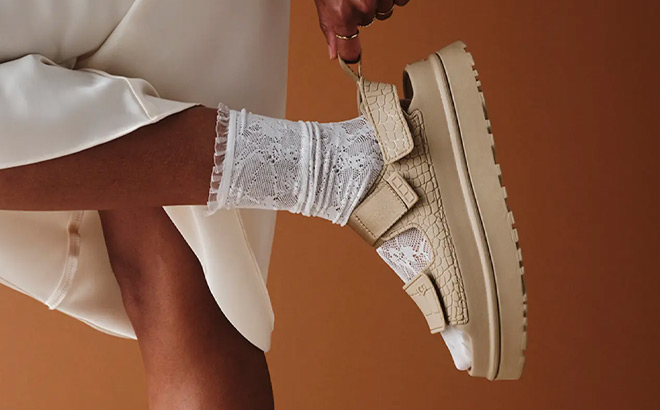 A Person Wearing UGG GoldenGlow Embossed Platform Sandals