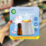 A Woman Holding Air Wick Essential Mist Starter Kit