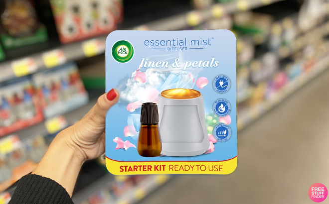 A Woman Holding Air Wick Essential Mist Starter Kit