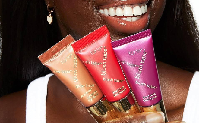 A Woman Holding Tarte Blush Glow Tape Travel Set