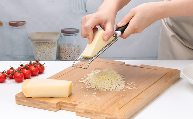 A Woman Using the Rainspire Professional Handheld Cheese Grater
