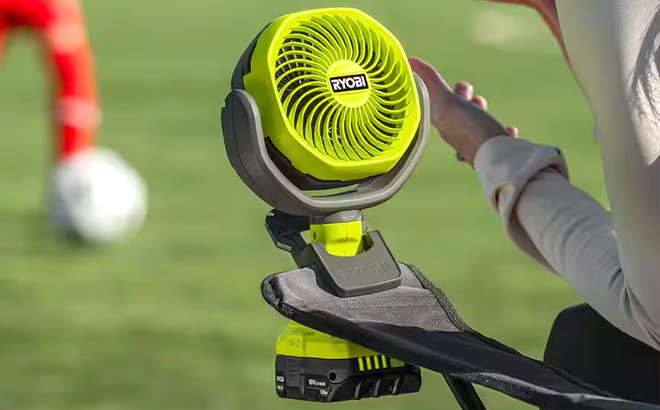 Ryobi ONE 18V Cordless 4 Inch Clamp Fan on a Beach Chair