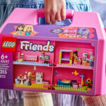 A Girl Holding the LEGO Friends Creative Dollhouse Suitcase Building Kit