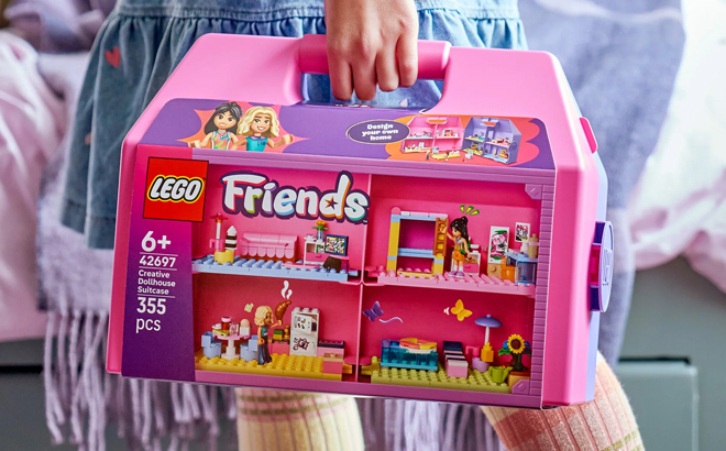 A Girl Holding the LEGO Friends Creative Dollhouse Suitcase Building Kit