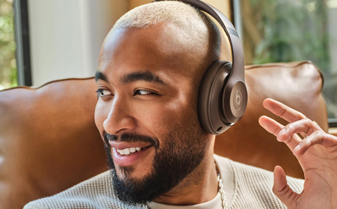 A Man Wearing Beats Studio Pro Premium Wireless Over Ear Headphones in Deep Brown