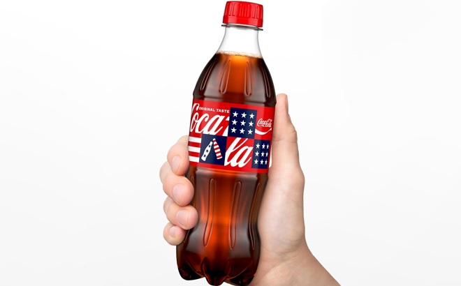 A Person Holding Coca Cola Soda Drink Bottle A Person Holding Coca Cola Soda Drink Bottle