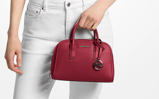 A Person Holding Michael Kors Ashton Small Messenger Bag A Person Holding Michael Kors Ashton Small Messenger Bag