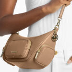 A Person Holding Michael Kors Merritt Small Pebbled Leather Crossbody Bag