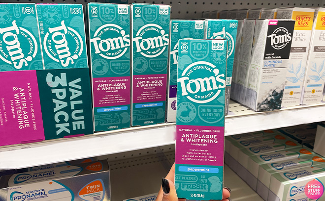 A Person Holding Toms Of Maine Toothpaste