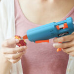 A Person Using Glue Gun