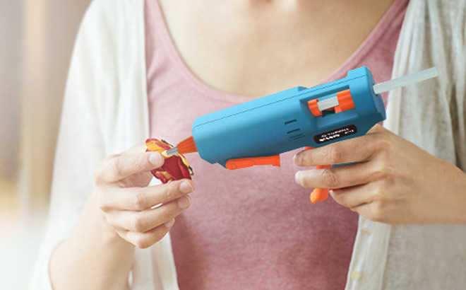 A Person Using Glue Gun A Person Using Glue Gun