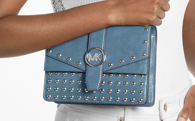 A Person Wearing the Michael Kors Greenwich Small Studded Distressed Crossbody Bag