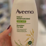 A Peson Holding the Aveeno Moisturizing Daily Body Wash at a Store