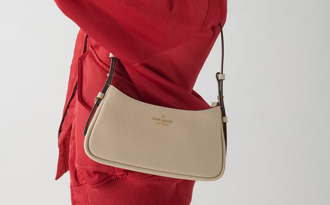 A Woman Wearing Kate Spade Juliette Small Shoulder Bag in Light Sand