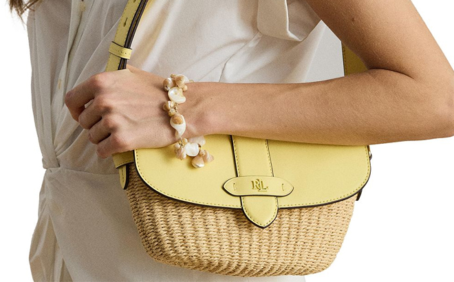 A Woman Wearing Ralph Lauren Lynden Small Straw Leather Shoulder Bag in Yellow A Woman Wearing Ralph Lauren Lynden Small Straw Leather Shoulder Bag in Yellow