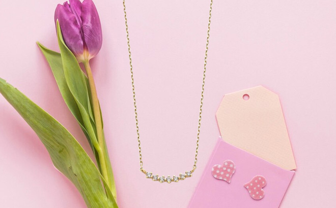 Lab Grown Diamond Accent Curved 10K Gold Necklace on the Table
