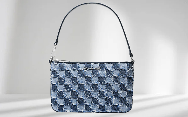Michael Kors Jet Set Travel Small Patchwork Denim Convertible Wristlet on a Gray Background
